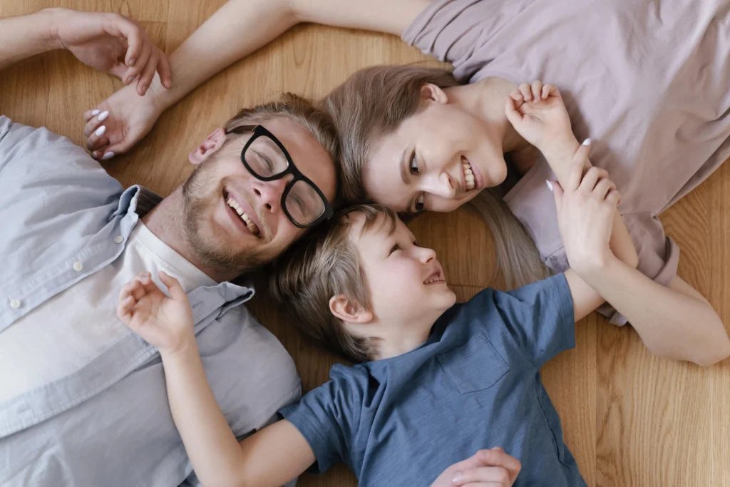 Parents with a child lying on the floor